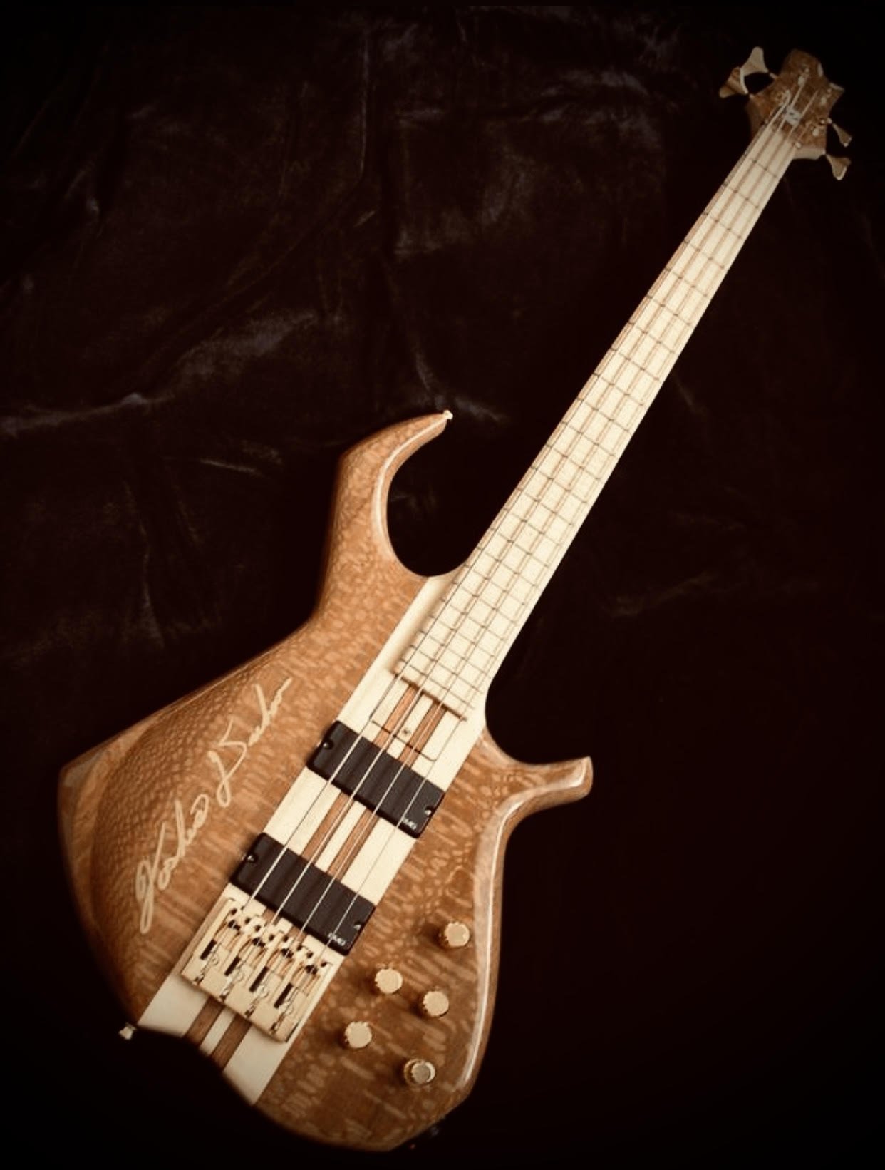 Finished signed lacewood bass on black velvet