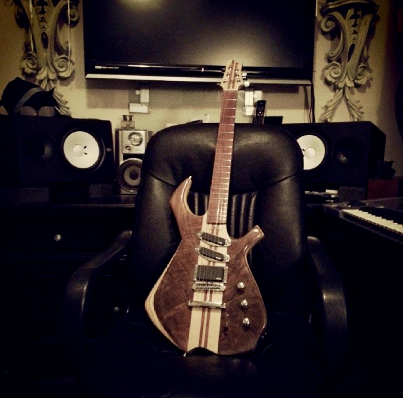 Custom guitar resting in a studio chair